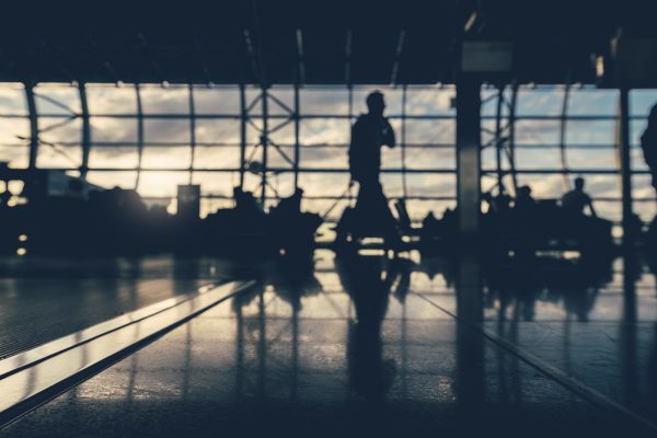 Defocused silhouettes of business people traveling on airport.